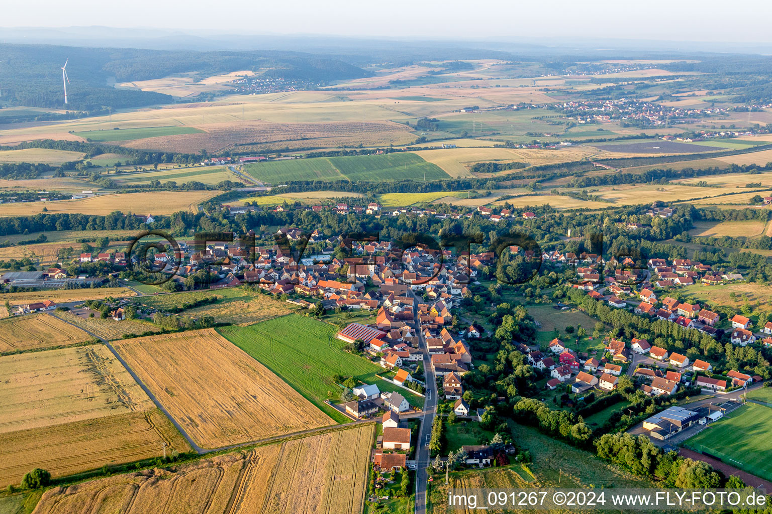 Village - view on the edge of agricultural fields and farmland in Steinbach am Donnersberg in the state Rhineland-Palatinate, Germany