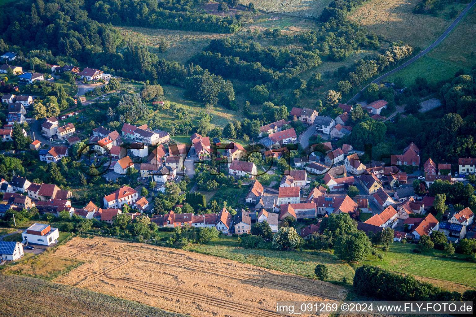 Aerial view of Village - view on the edge of agricultural fields and farmland in Jakobsweiler in the state Rhineland-Palatinate, Germany