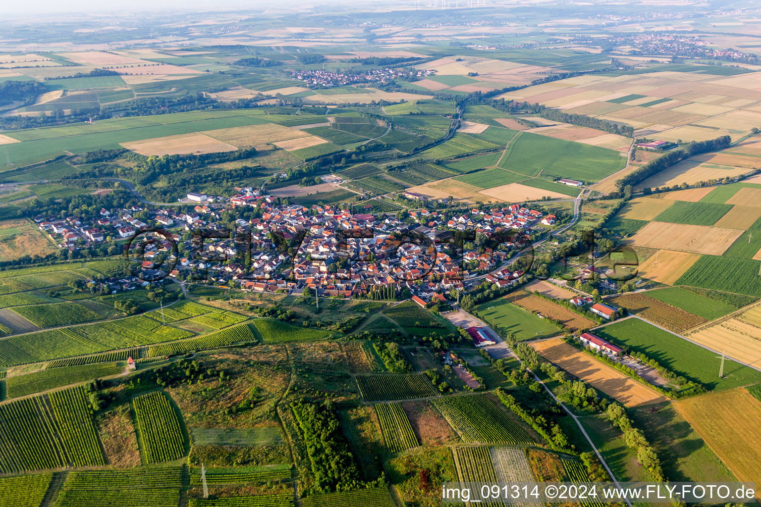 Village - view on the edge of agricultural fields and farmland in Woerrstadt in the state Rhineland-Palatinate, Germany