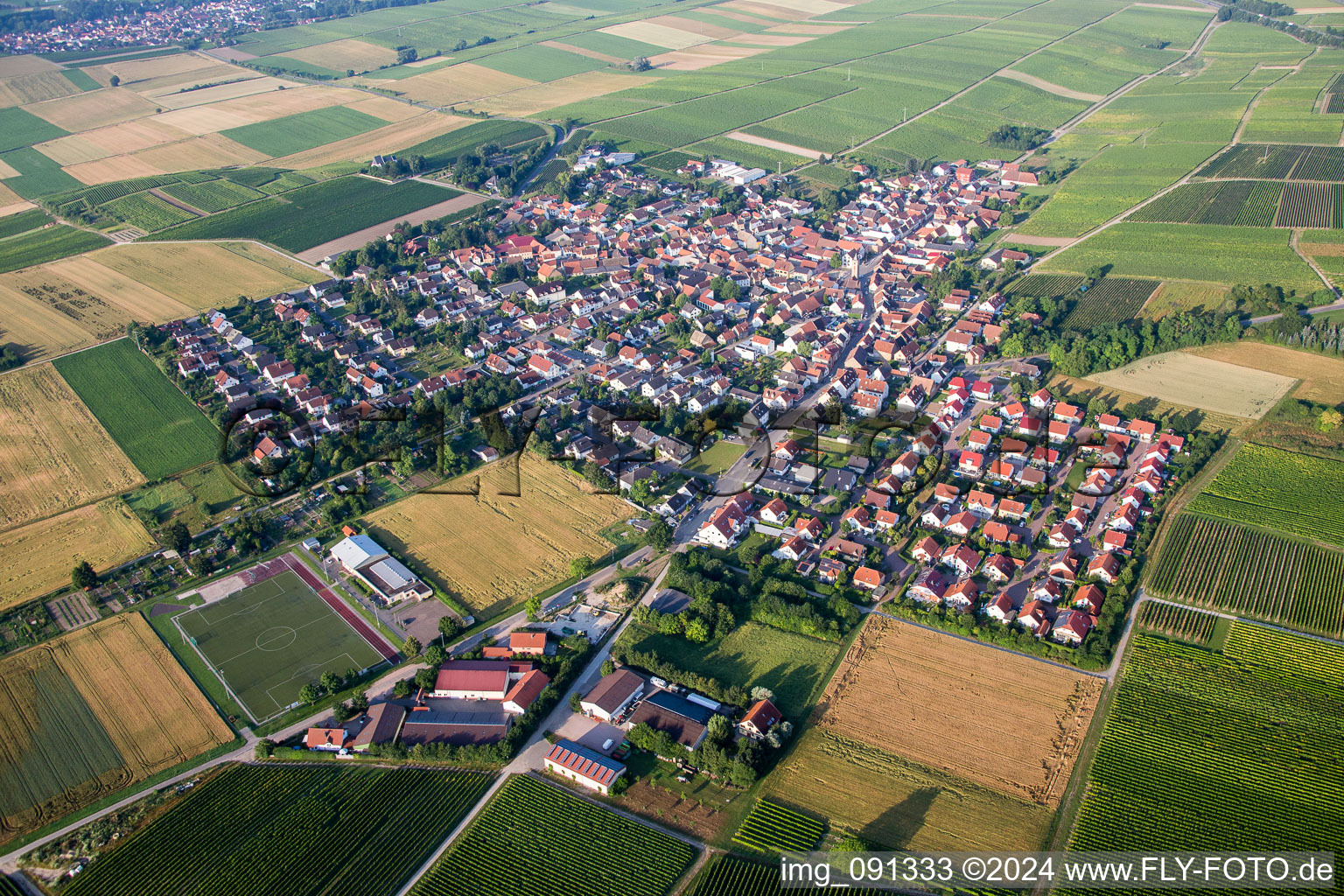 Village - view on the edge of agricultural fields and farmland in Udenheim in the state Rhineland-Palatinate, Germany