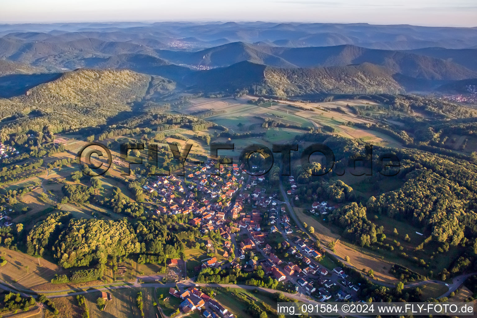 Village - view on the edge of agricultural fields and farmland in Voelkersweiler in the state Rhineland-Palatinate, Germany