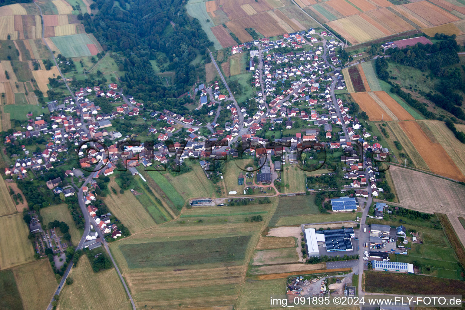 Aerial view of Village - view on the edge of agricultural fields and farmland in Donsieders in the state Rhineland-Palatinate