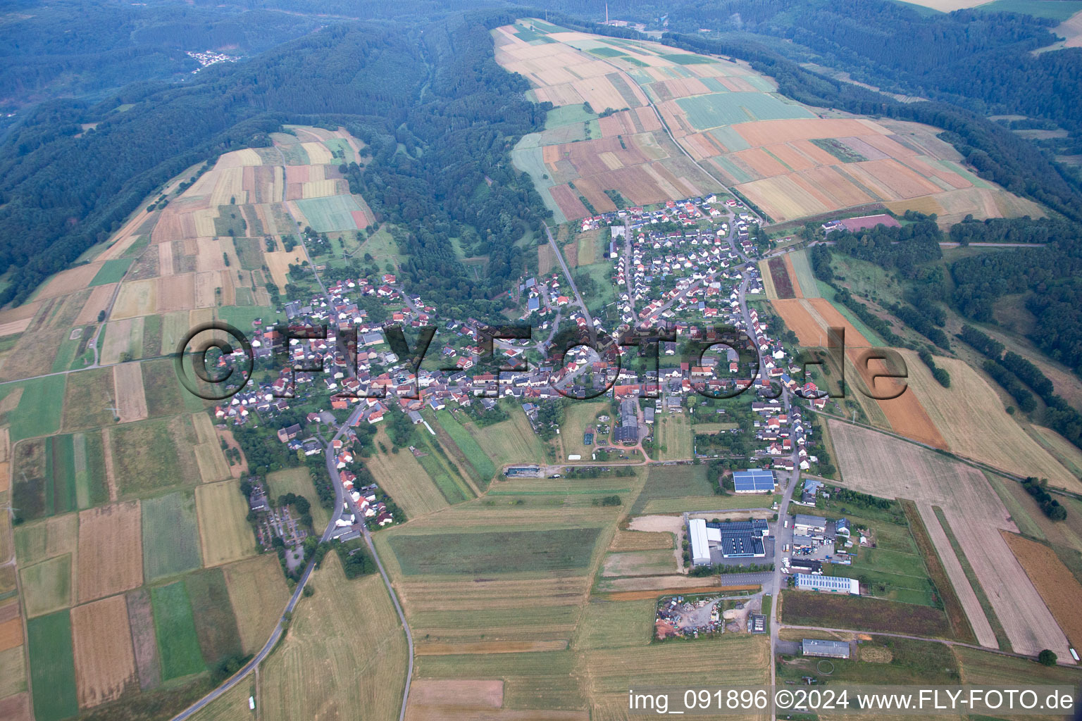 Aerial photograpy of Village - view on the edge of agricultural fields and farmland in Donsieders in the state Rhineland-Palatinate