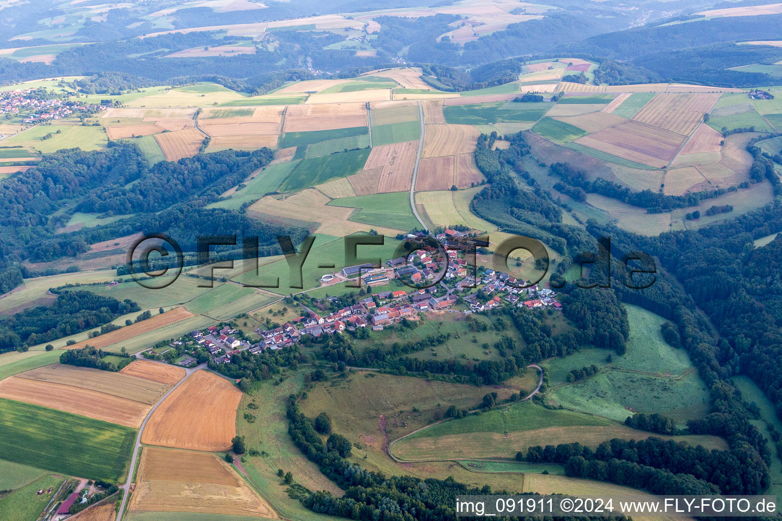 Village - view on the edge of agricultural fields and farmland in Schauerberg in the state Rhineland-Palatinate, Germany