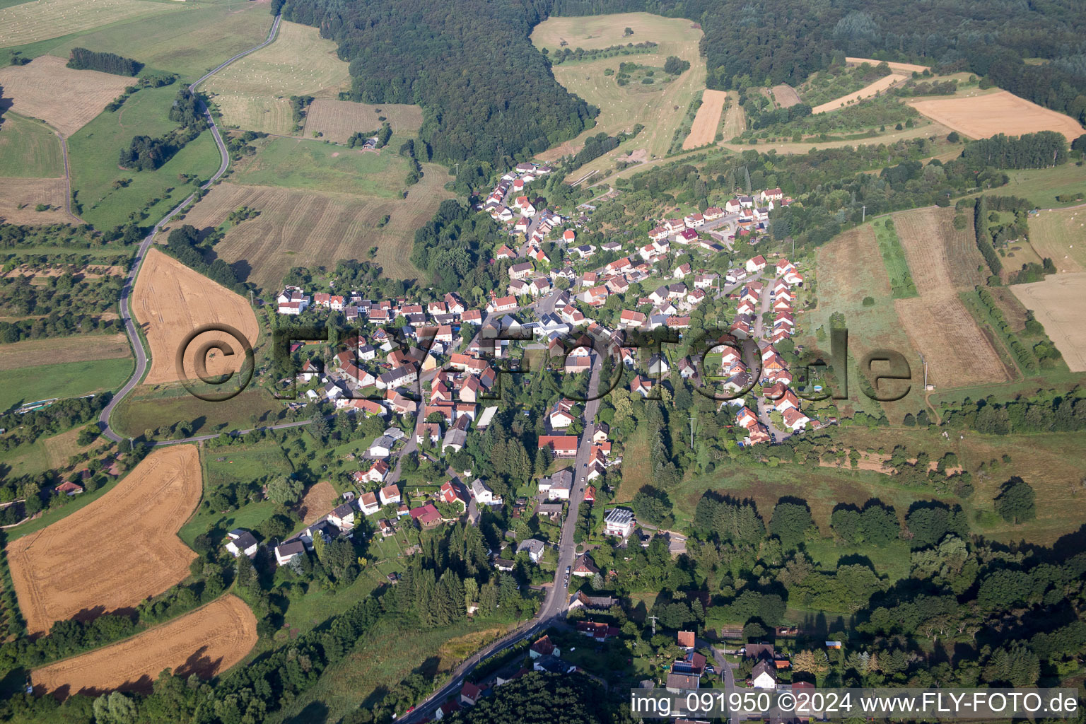 Village - view on the edge of agricultural fields and farmland in Frohnhofen in the state Rhineland-Palatinate, Germany