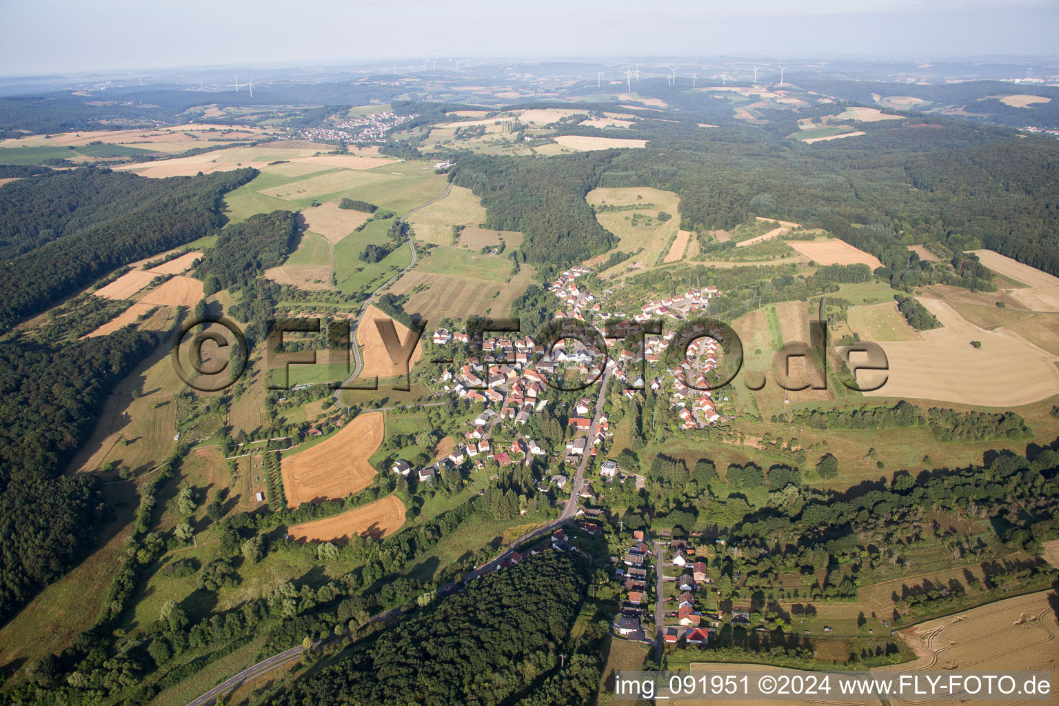 Aerial view of Village - view on the edge of agricultural fields and farmland in Frohnhofen in the state Rhineland-Palatinate, Germany