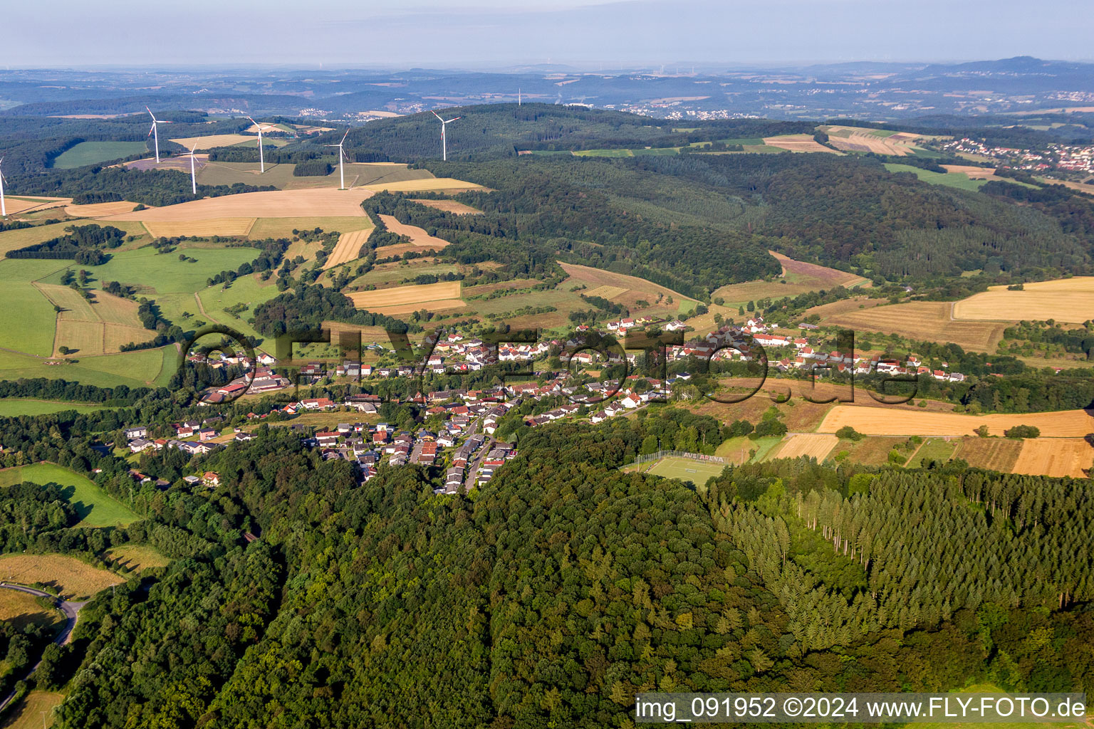 Village - view on the edge of agricultural fields and farmland in Hoof in the state Saarland, Germany