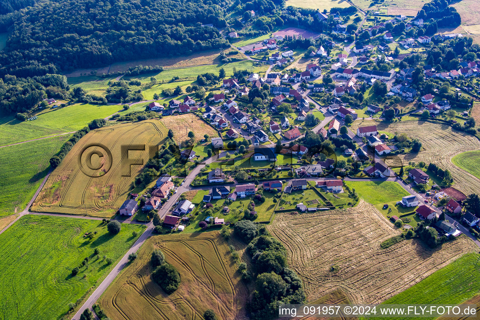 Aerial view of Village - view on the edge of agricultural fields and farmland in Reitscheid in the state Saarland, Germany