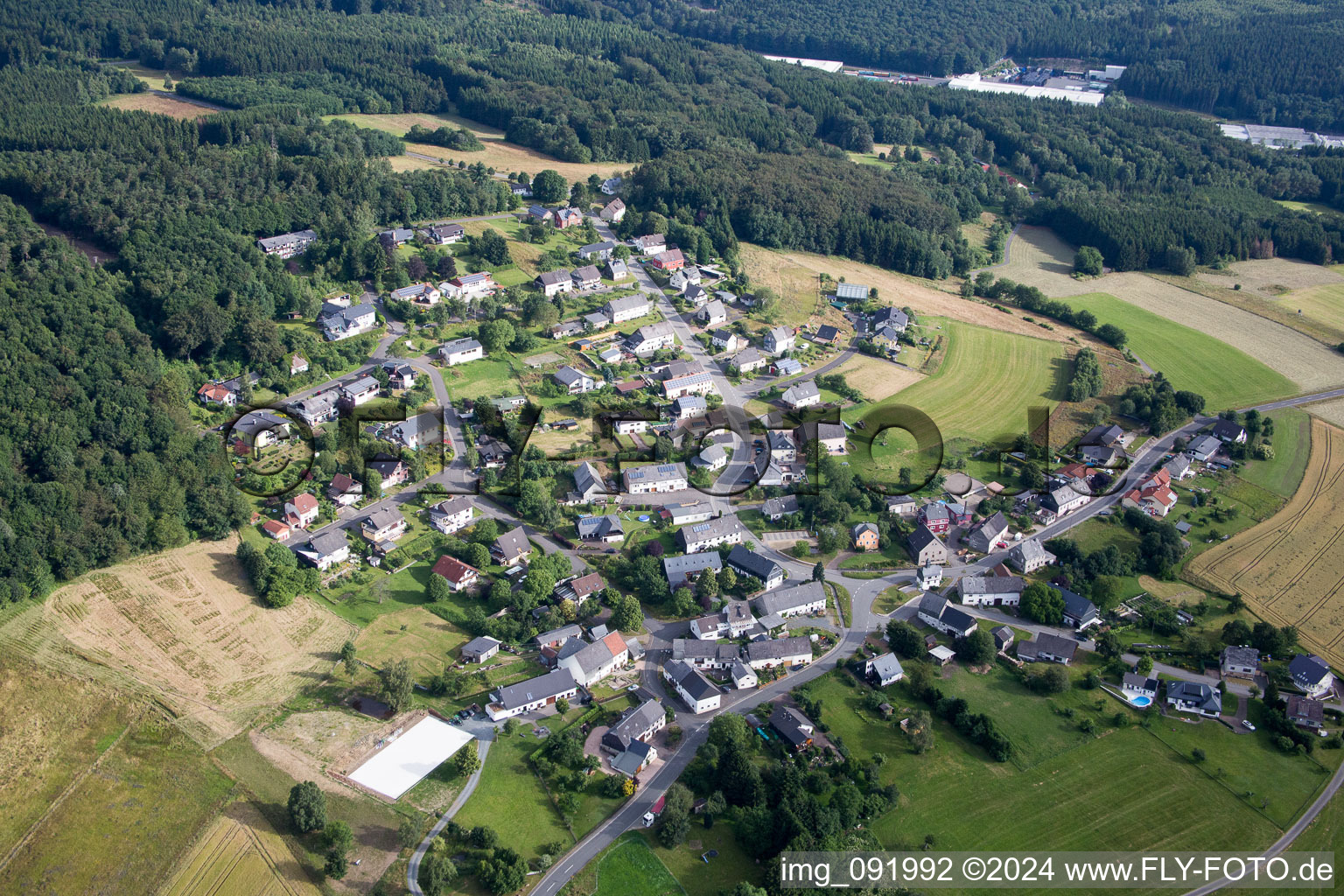 Village - view on the edge of agricultural fields and farmland in Hattgenstein in the state Rhineland-Palatinate, Germany