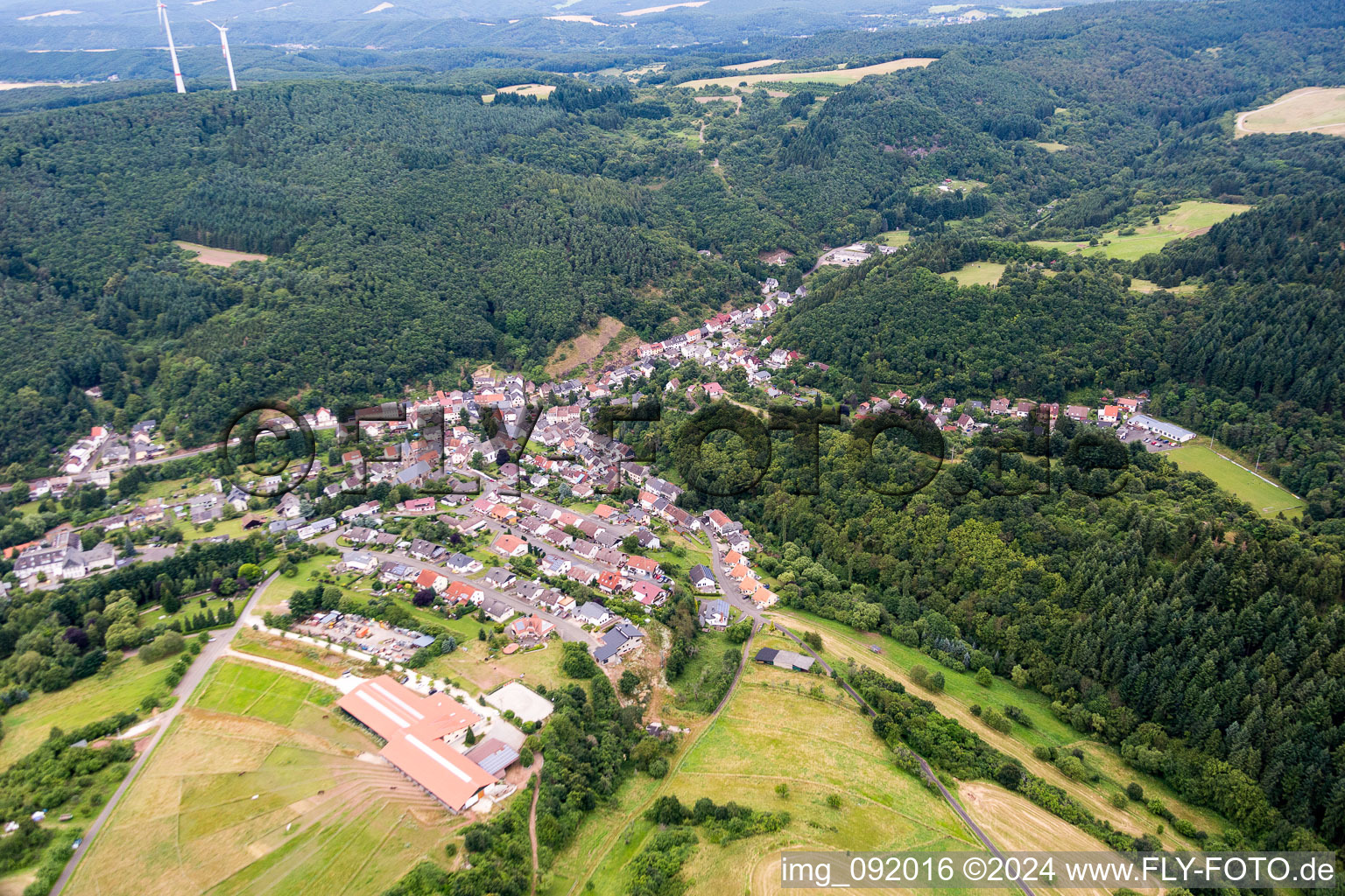 Village - view on the edge of agricultural fields and farmland in the district Kirchenbollenbach in Idar-Oberstein in the state Rhineland-Palatinate, Germany