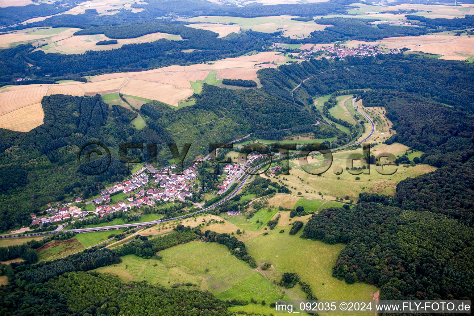 Village - view on the edge of agricultural fields and farmland in Heinzenhausen in the state Rhineland-Palatinate, Germany