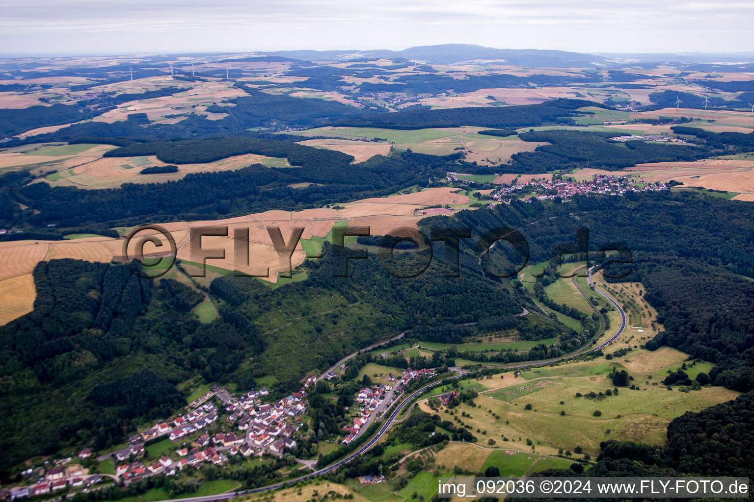 Aerial view of Village - view on the edge of agricultural fields and farmland in Heinzenhausen in the state Rhineland-Palatinate, Germany