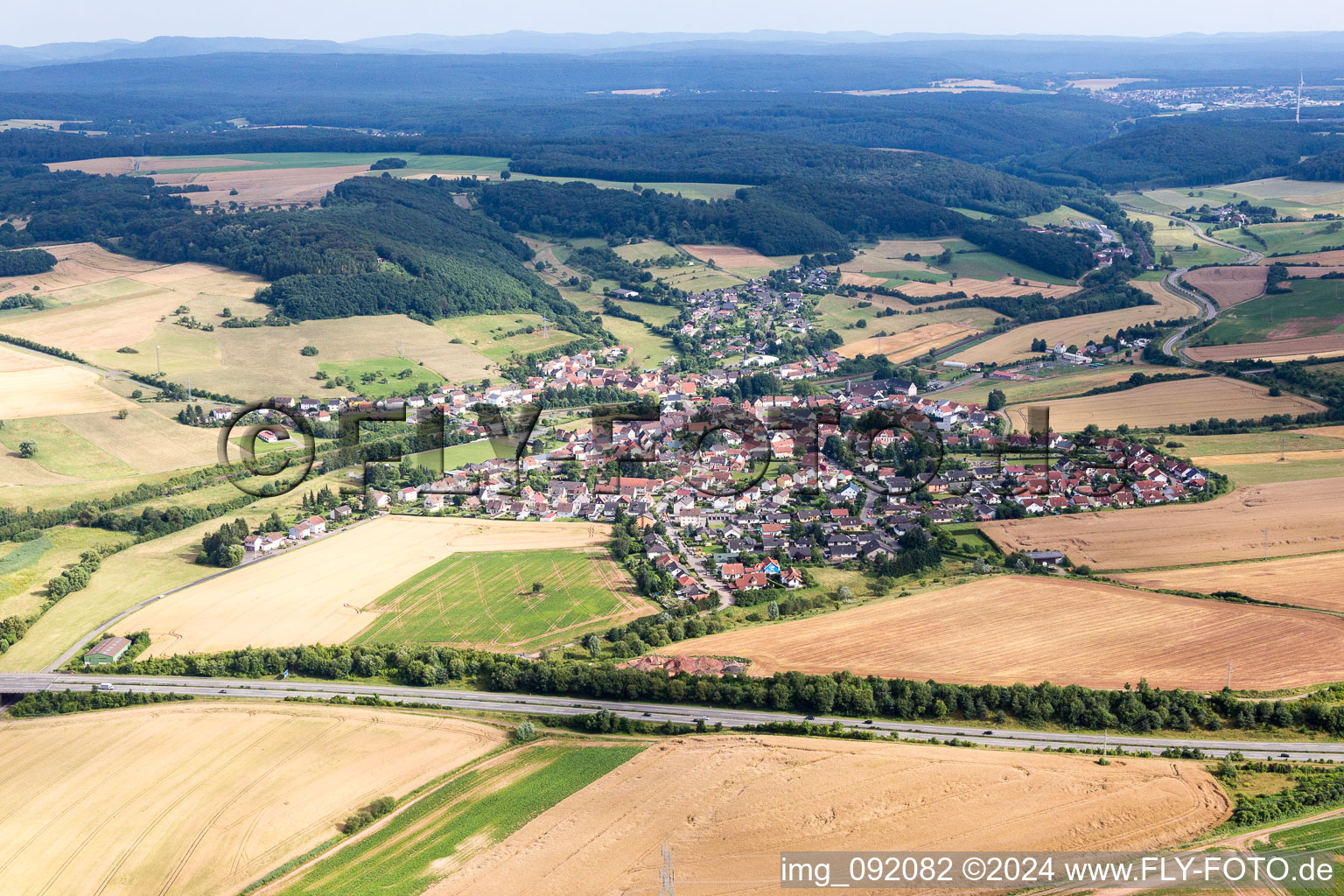 Village - view on the edge of agricultural fields and farmland in Muenchweiler an der Alsenz in the state Rhineland-Palatinate, Germany