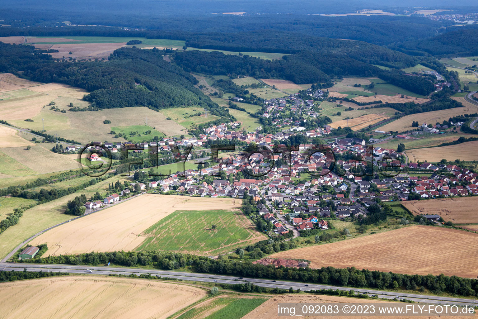 Aerial view of Village - view on the edge of agricultural fields and farmland in Muenchweiler an der Alsenz in the state Rhineland-Palatinate, Germany