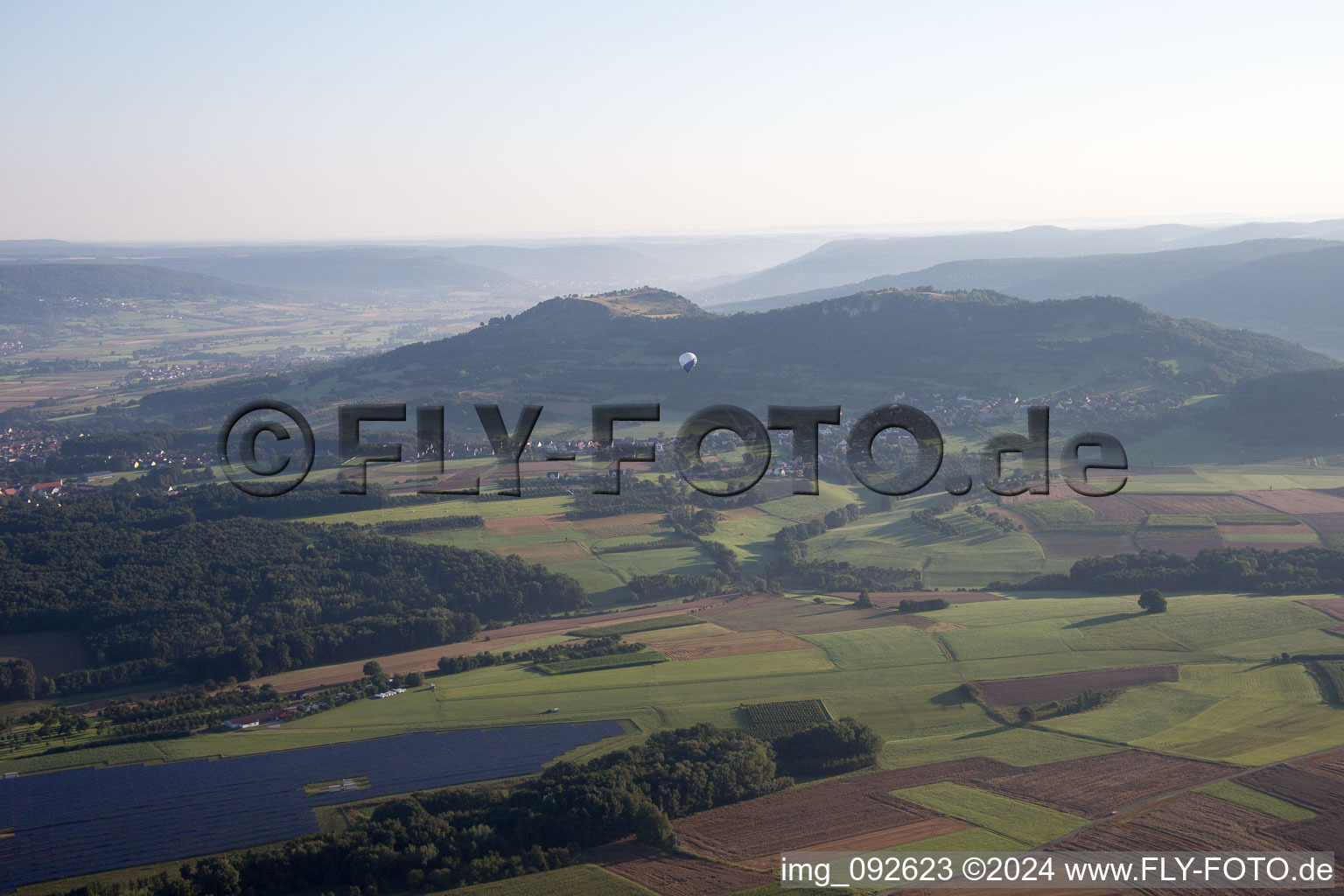 Hot air balloon in morning dust flying over the airspace in Pinzberg in the state Bavaria, Germany