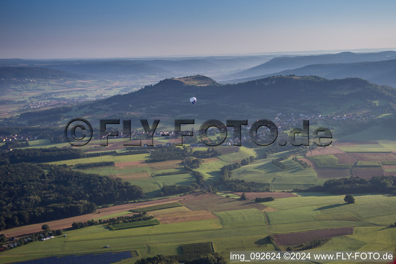 Hot air balloon in morning dust flying over the airspace in Pinzberg in the state Bavaria, Germany