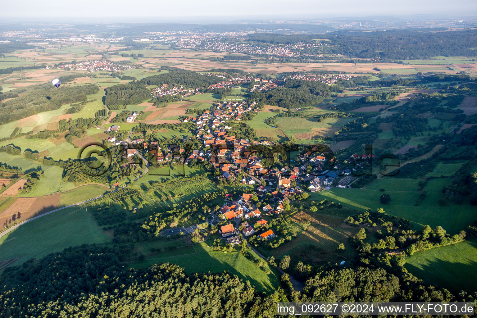 Village - view on the edge of agricultural fields and farmland in Schlaifhausen in the state Bavaria, Germany