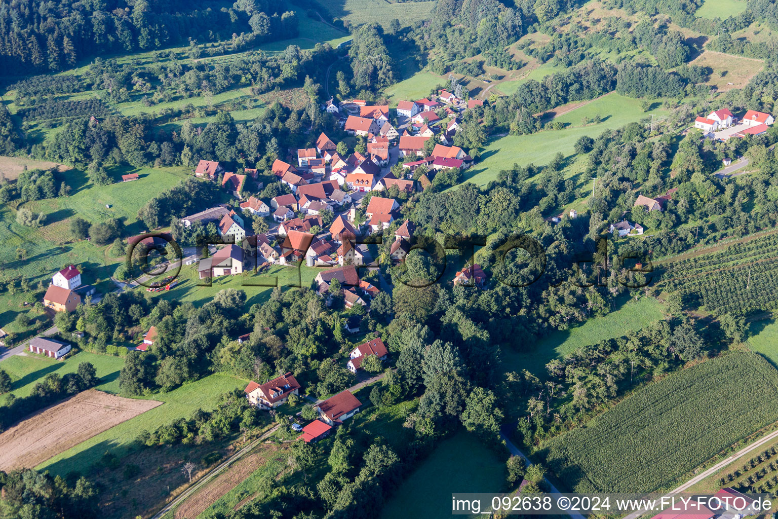 Village - view on the edge of agricultural fields and farmland in the district Pommer in Igensdorf in the state Bavaria, Germany