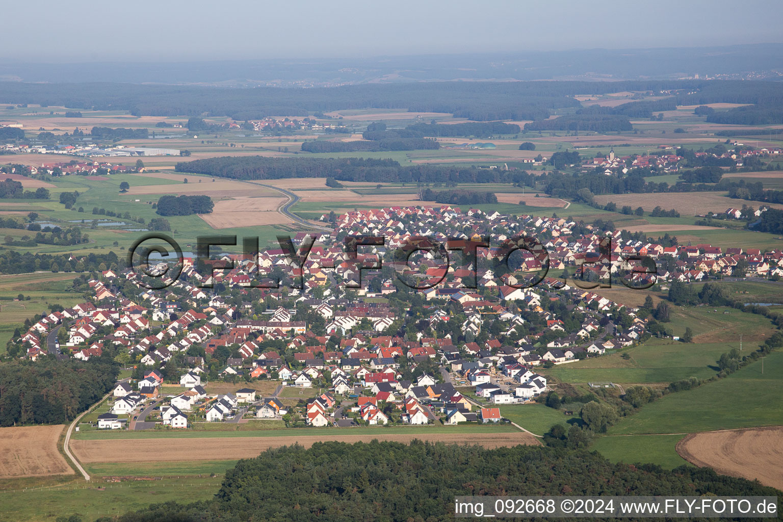 Village - view on the edge of agricultural fields and farmland in Grossenseebach in the state Bavaria, Germany