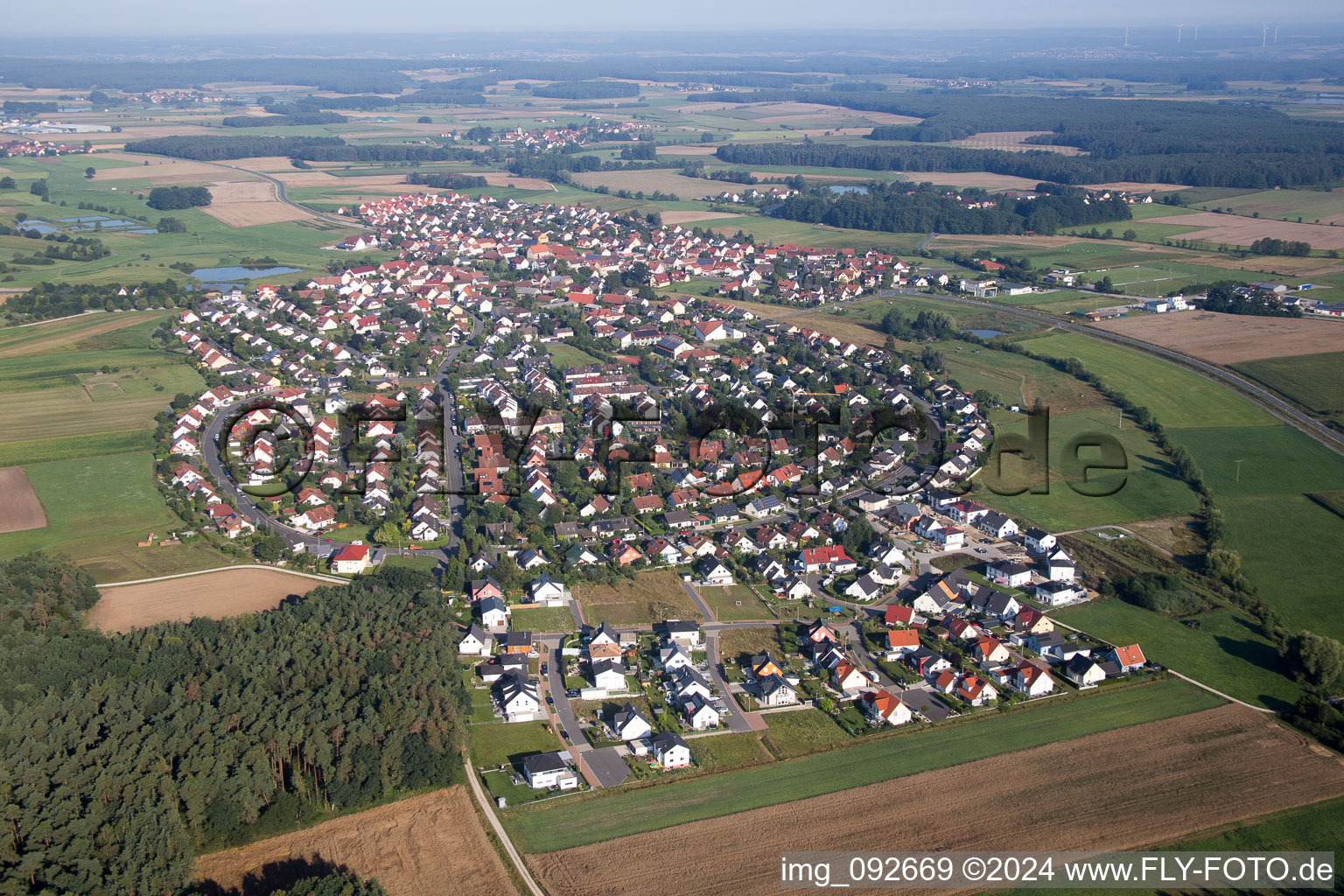 Aerial view of Village - view on the edge of agricultural fields and farmland in Grossenseebach in the state Bavaria, Germany