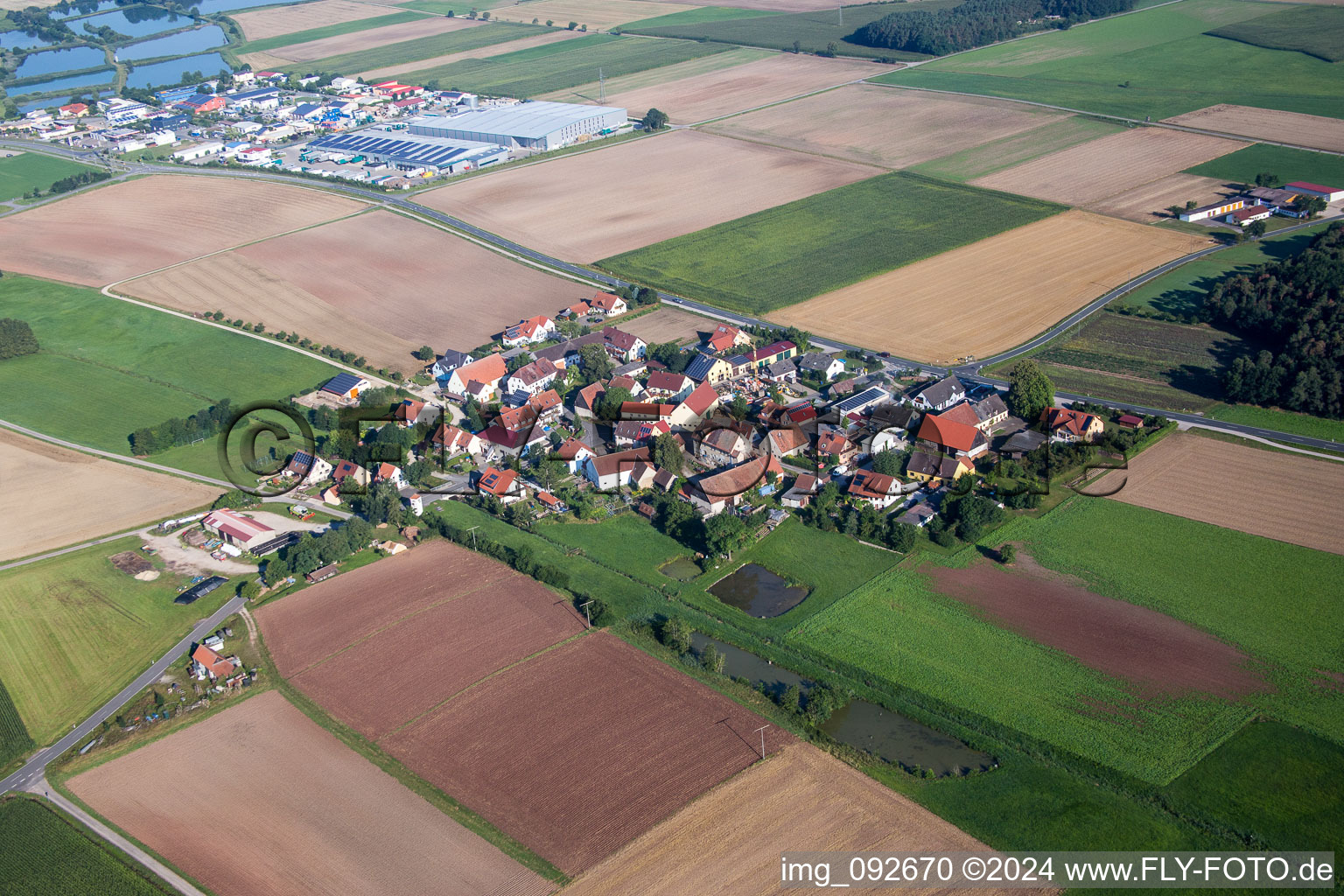 Village - view on the edge of agricultural fields and farmland in Reinersdorf in the state Bavaria, Germany