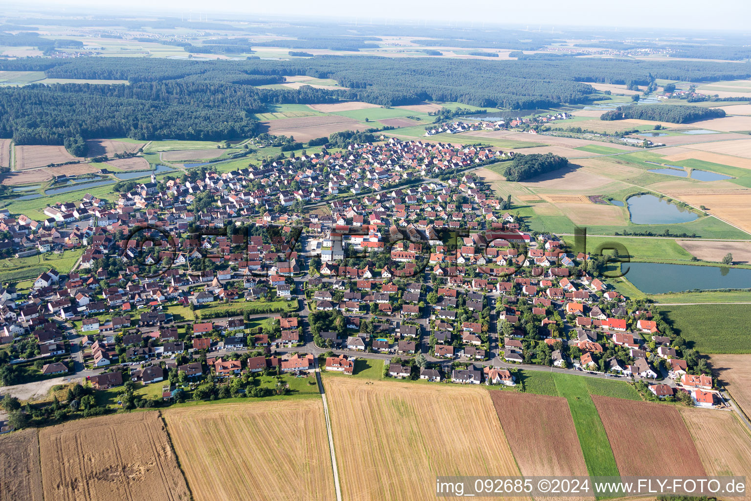 Village - view on the edge of agricultural fields and carp lakes in Weisendorf in the state Bavaria, Germany