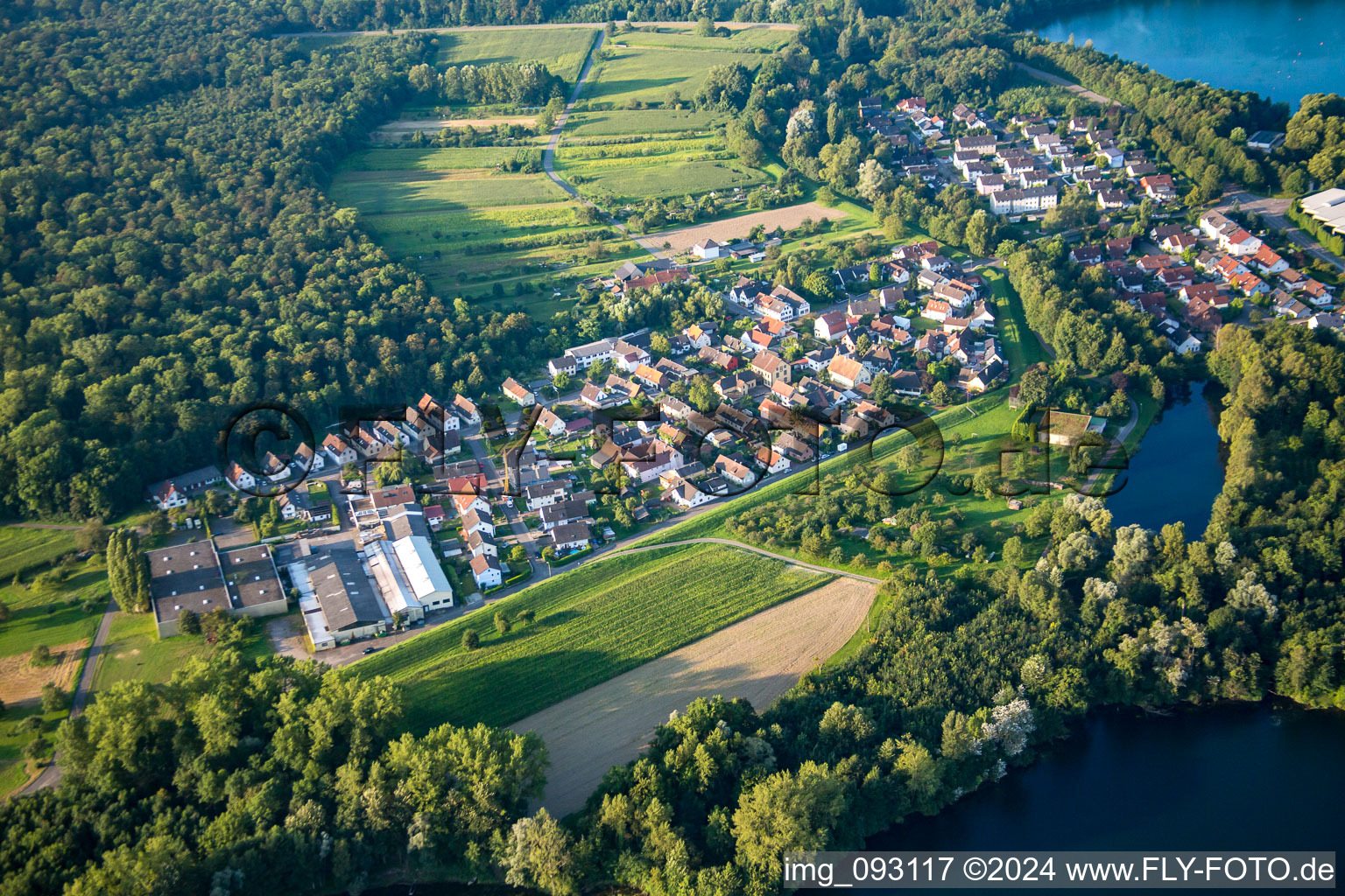 Village on the lake bank areas of lake for gravel mining near the river Rhine in the district Grauelsbaum in Lichtenau in the state Baden-Wurttemberg, Germany