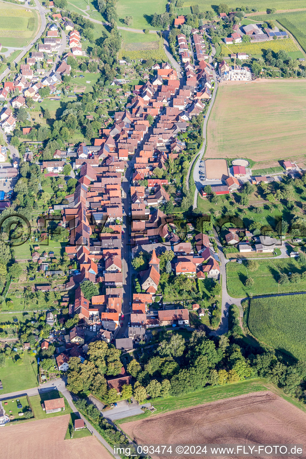 Aerial view of Village - view on the edge of agricultural fields and farmland in Schuetzingen in the state Baden-Wurttemberg, Germany