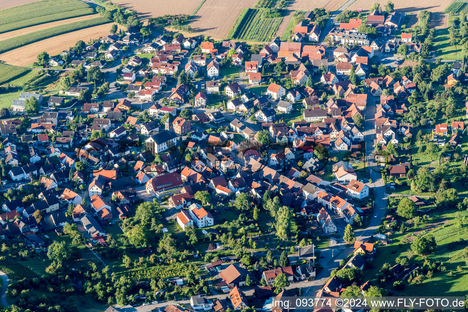 Aerial view of Village - view on the edge of agricultural fields and farmland in Winzerhausen in the state Baden-Wurttemberg, Germany