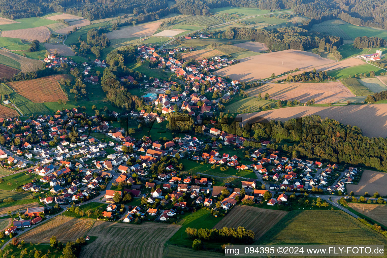 Aerial view of Village - view on the edge of agricultural fields and farmland in Herdwangen-Schoenach in the state Baden-Wurttemberg, Germany