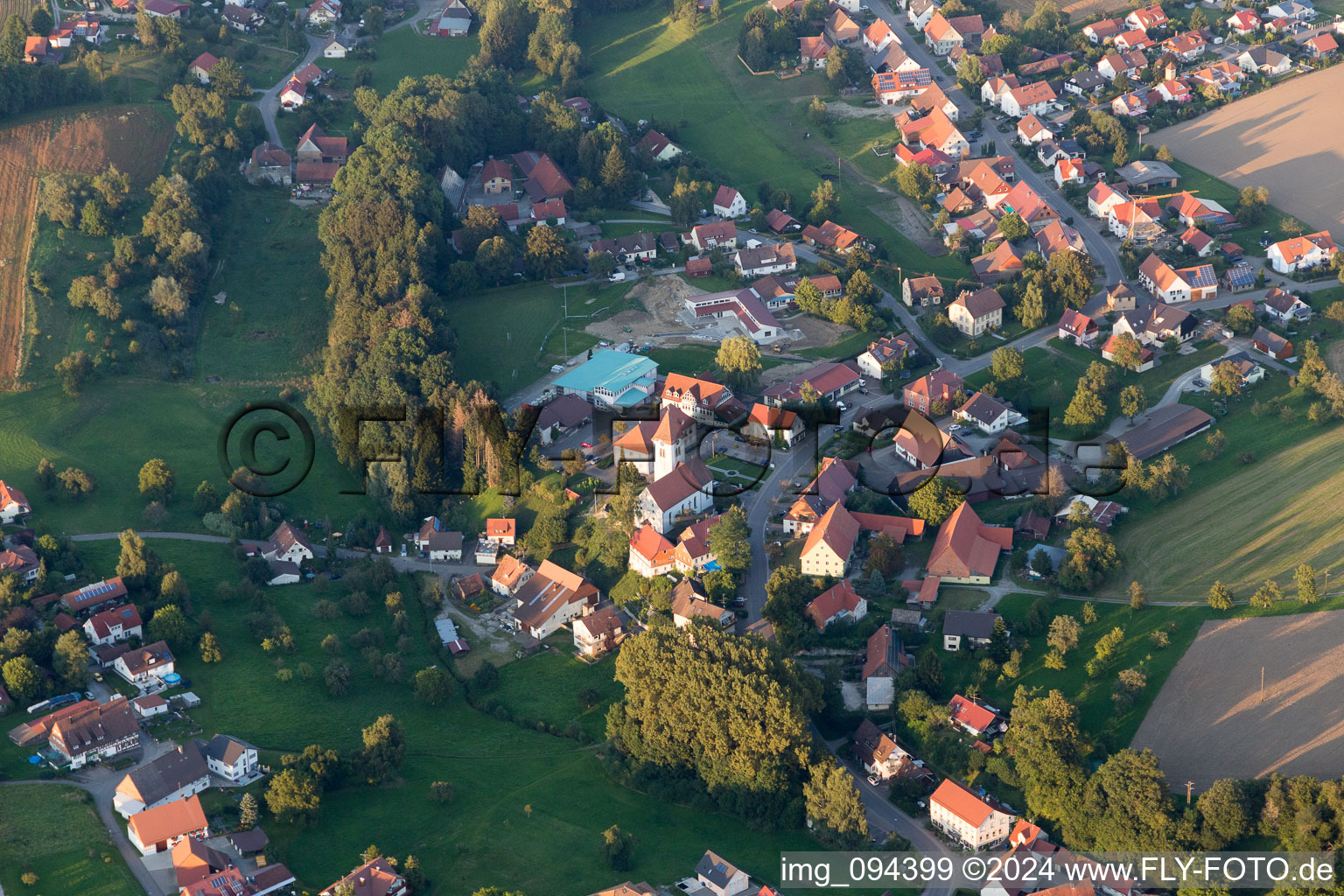 Oblique view of Village - view on the edge of agricultural fields and farmland in Herdwangen-Schoenach in the state Baden-Wurttemberg, Germany