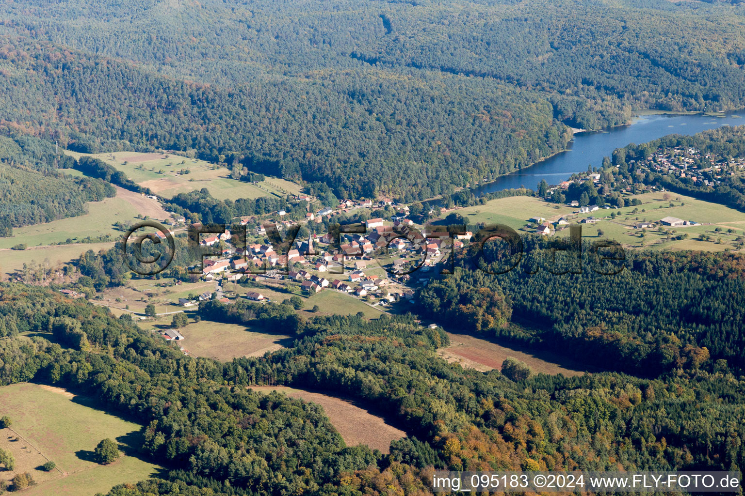 Aerial view of Village on the lake bank areas of Etang de Haspelschiedt in Haspelschiedt in Grand Est, France