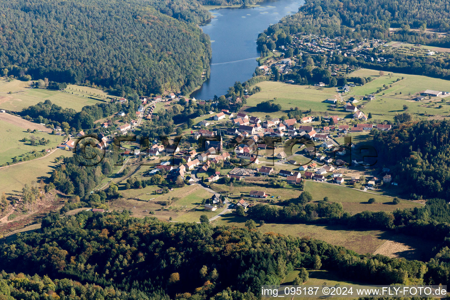 Village on the lake bank areas of Etang de Haspelschiedt in Haspelschiedt in Grand Est, France from above