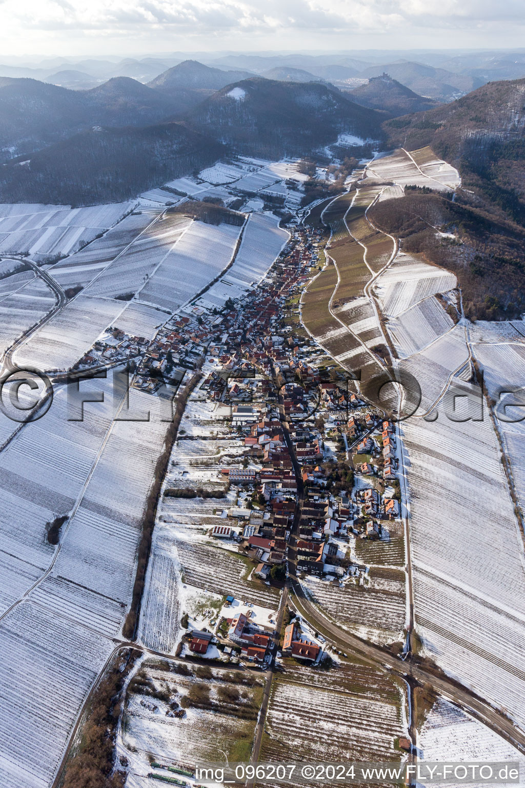 Aerial view of Wintry snowy Village - view on the edge of snowed wine yards in Ranschbach in the state Rhineland-Palatinate, Germany