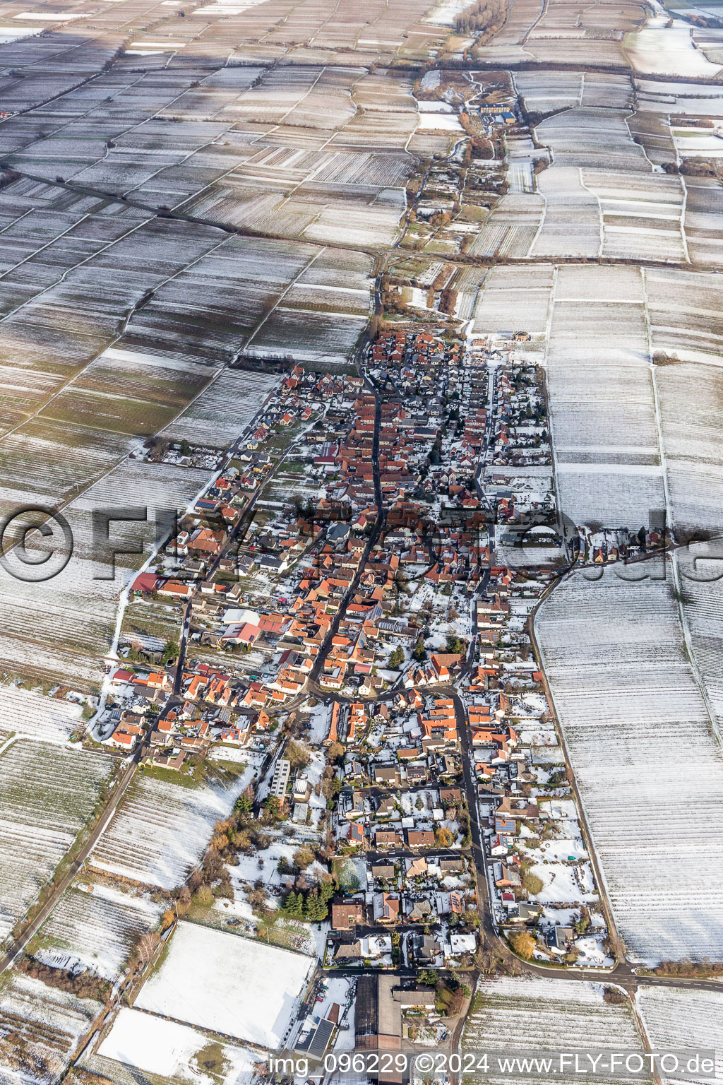 Wintry snowy Village - view on the edge of agricultural fields and farmland in Roschbach in the state Rhineland-Palatinate, Germany