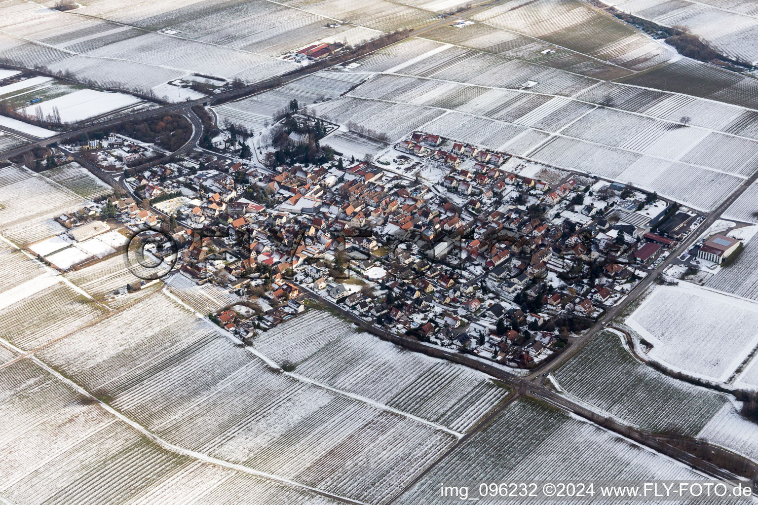 Wintry snowy Village - view on the edge of agricultural fields and farmland in Walsheim in the state Rhineland-Palatinate, Germany