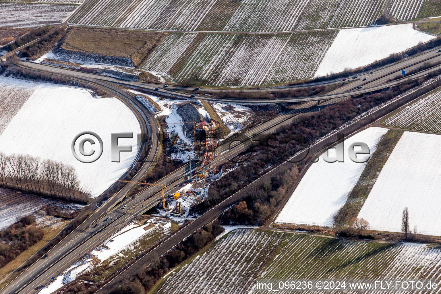 Wintry snowy Routing and traffic lanes over the highway bridge in the motorway A 65 in Landau in der Pfalz in the state Rhineland-Palatinate, Germany