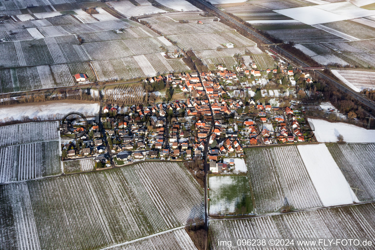 Wintry snowy Village - view on the edge of agricultural fields and farmland in Knoeringen in the state Rhineland-Palatinate, Germany