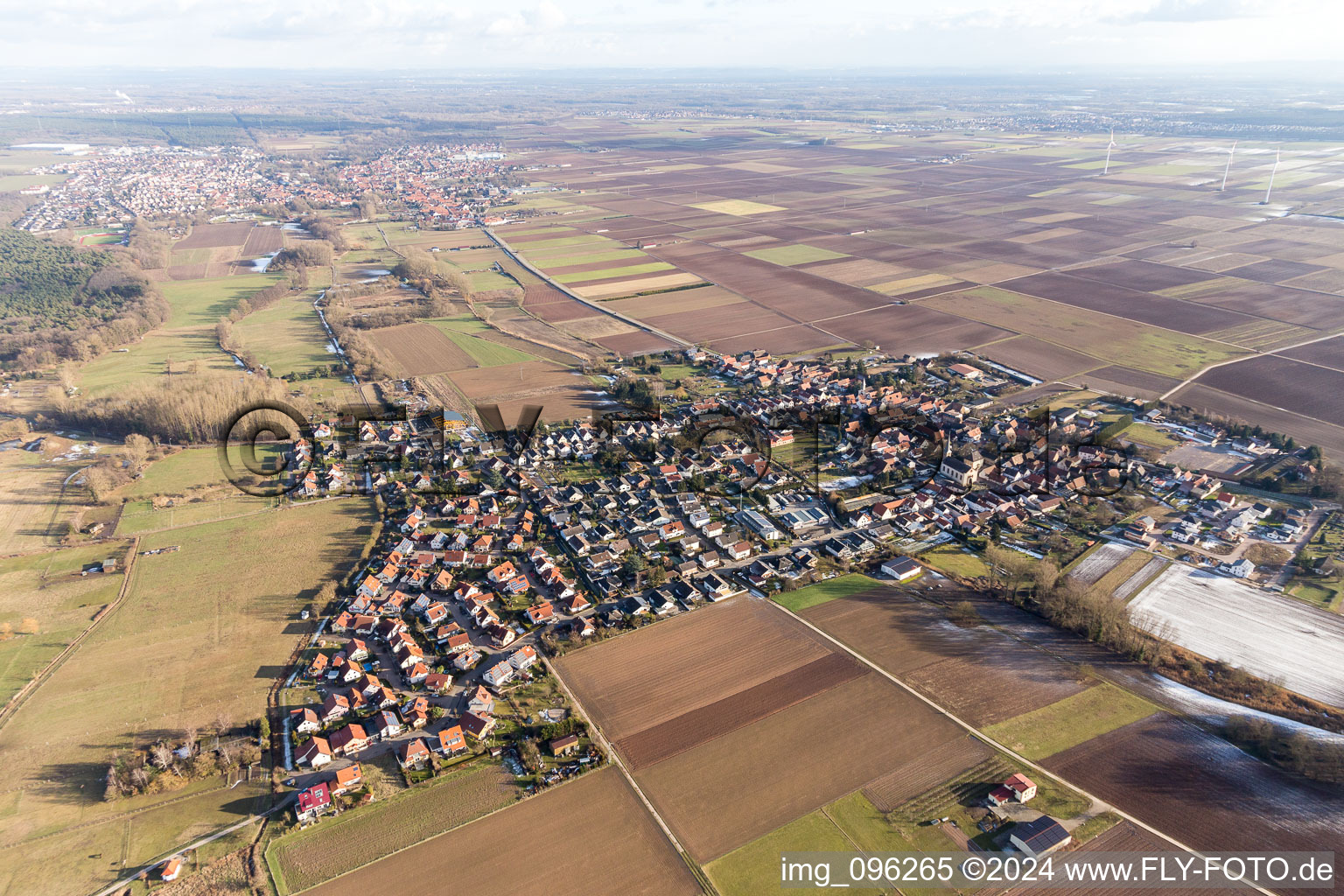 Village - view on the edge of agricultural fields and farmland in Knittelsheim in the state Rhineland-Palatinate, Germany