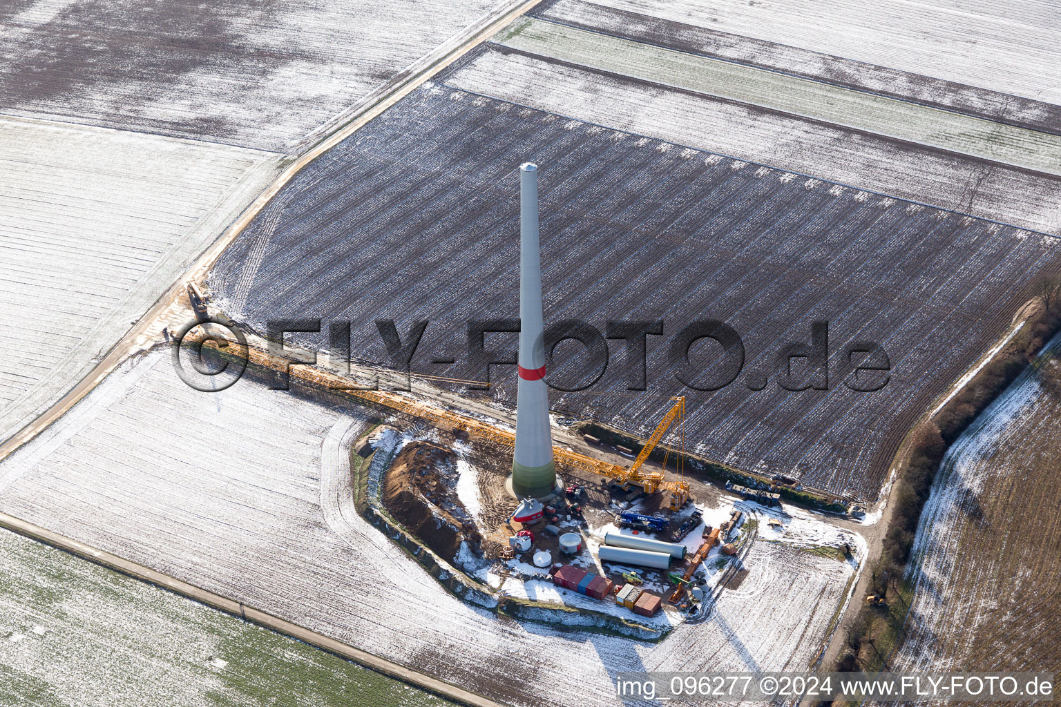 Aerial view of Wintry snowy Construction site for wind turbine installation in Hatzenbuehl in the state Rhineland-Palatinate, Germany