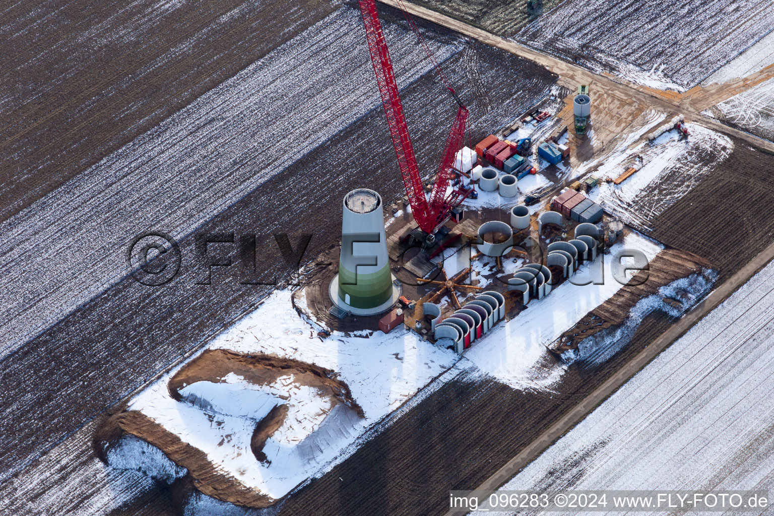 Aerial photograpy of Wintry snowy Construction site for wind turbine installation in Hatzenbuehl in the state Rhineland-Palatinate, Germany