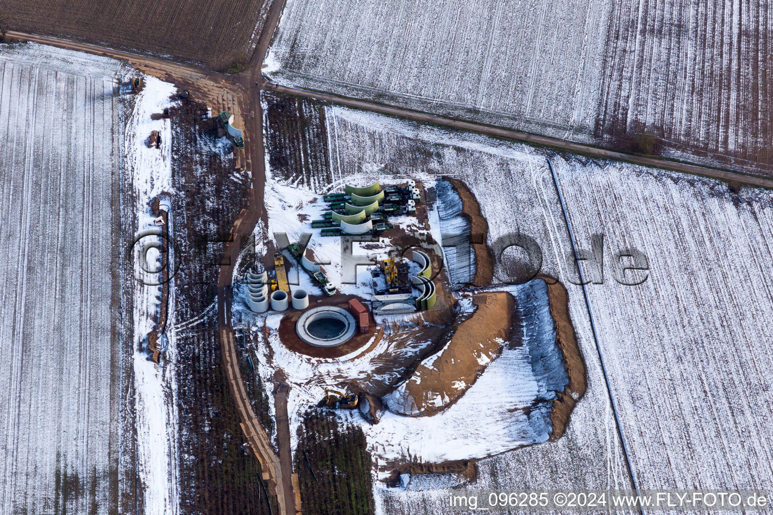 Oblique view of Wintry snowy Construction site for wind turbine installation in Hatzenbuehl in the state Rhineland-Palatinate, Germany