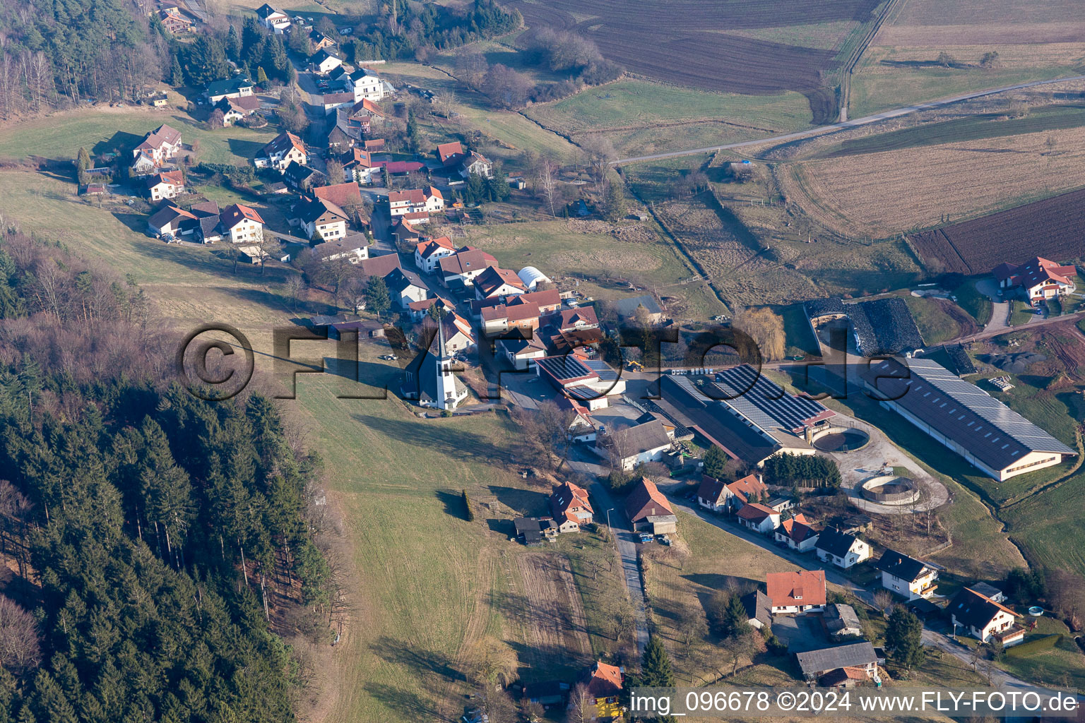 Aerial view of Village - view on the edge of agricultural fields and farmland in Kocherbach in the state Hesse, Germany