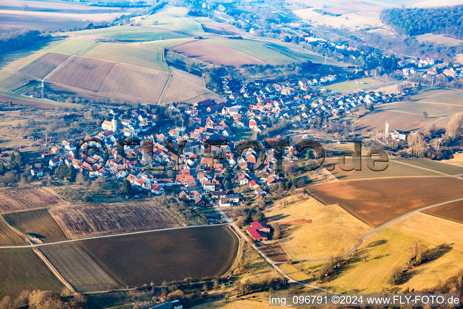 Village - view on the edge of agricultural fields and farmland in Wiebelsbach in the state Hesse, Germany