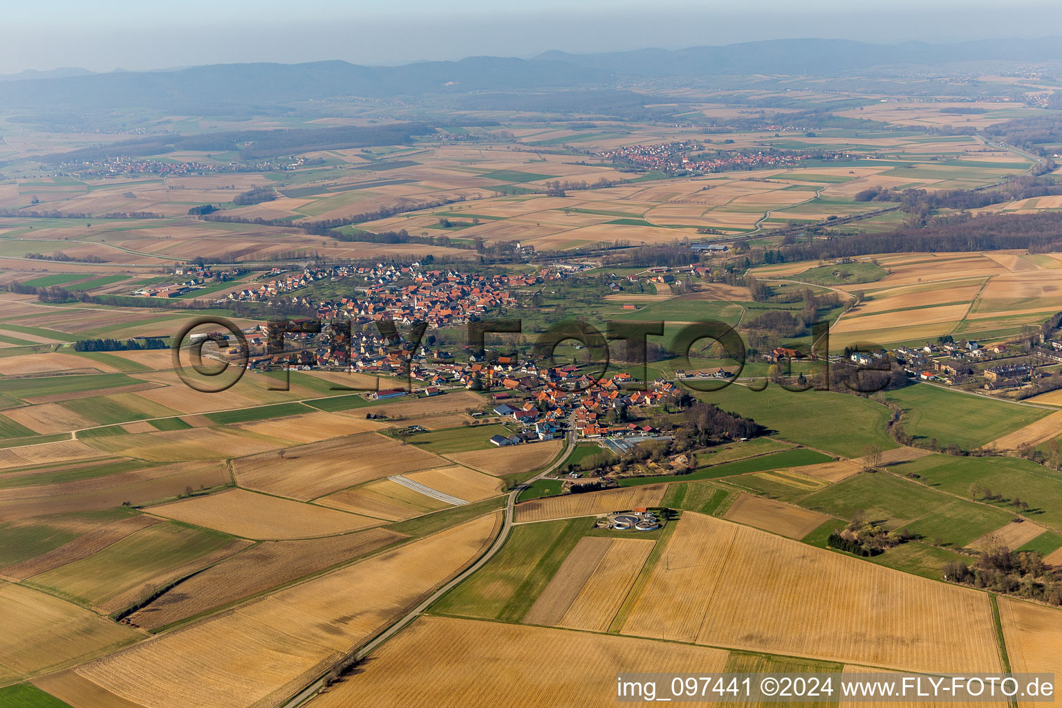 Village - view on the edge of agricultural fields and farmland in Hoffen in Grand Est, France