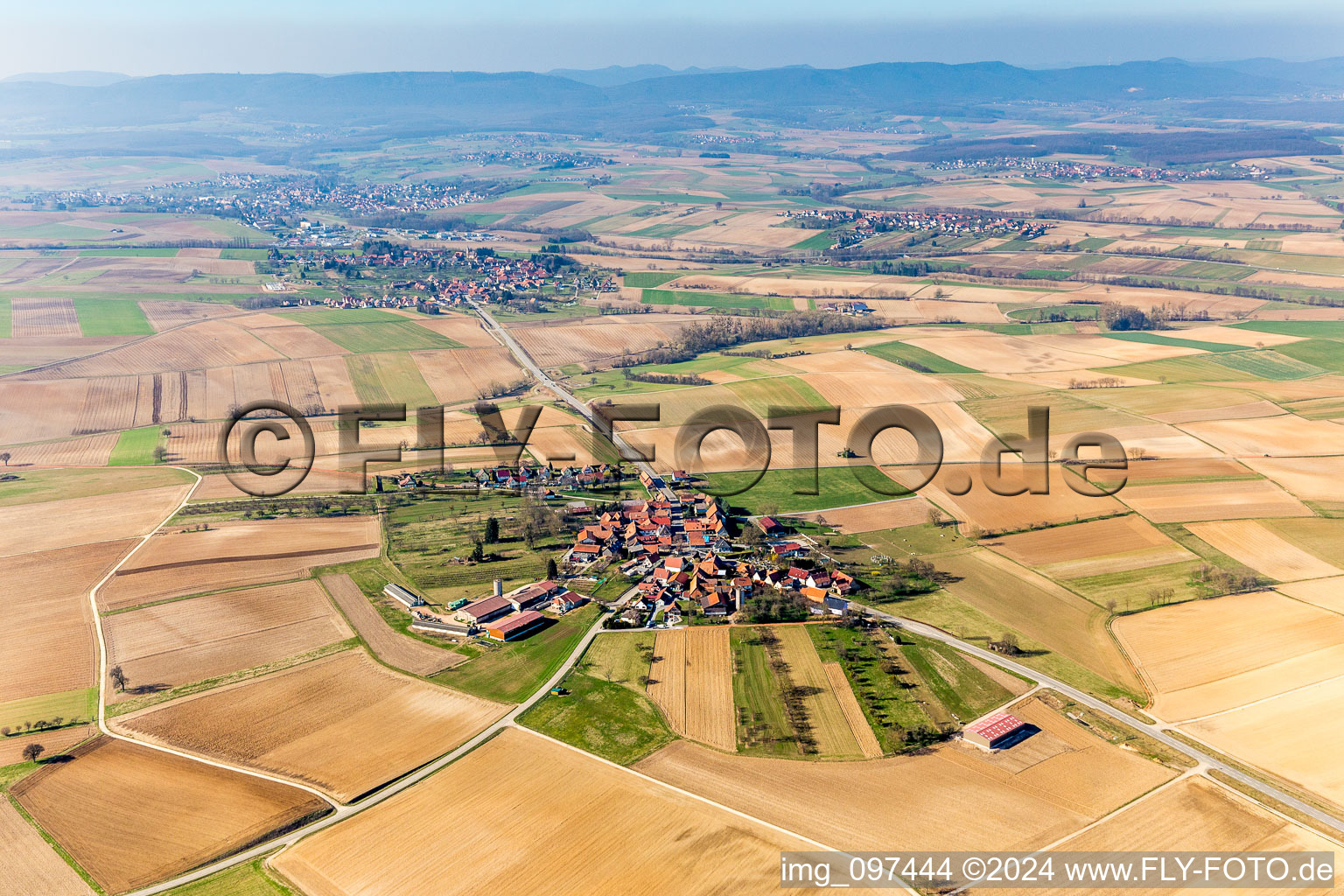 Village - view on the edge of agricultural fields and farmland in the district Kuhlendorf in Betschdorf in Grand Est, France