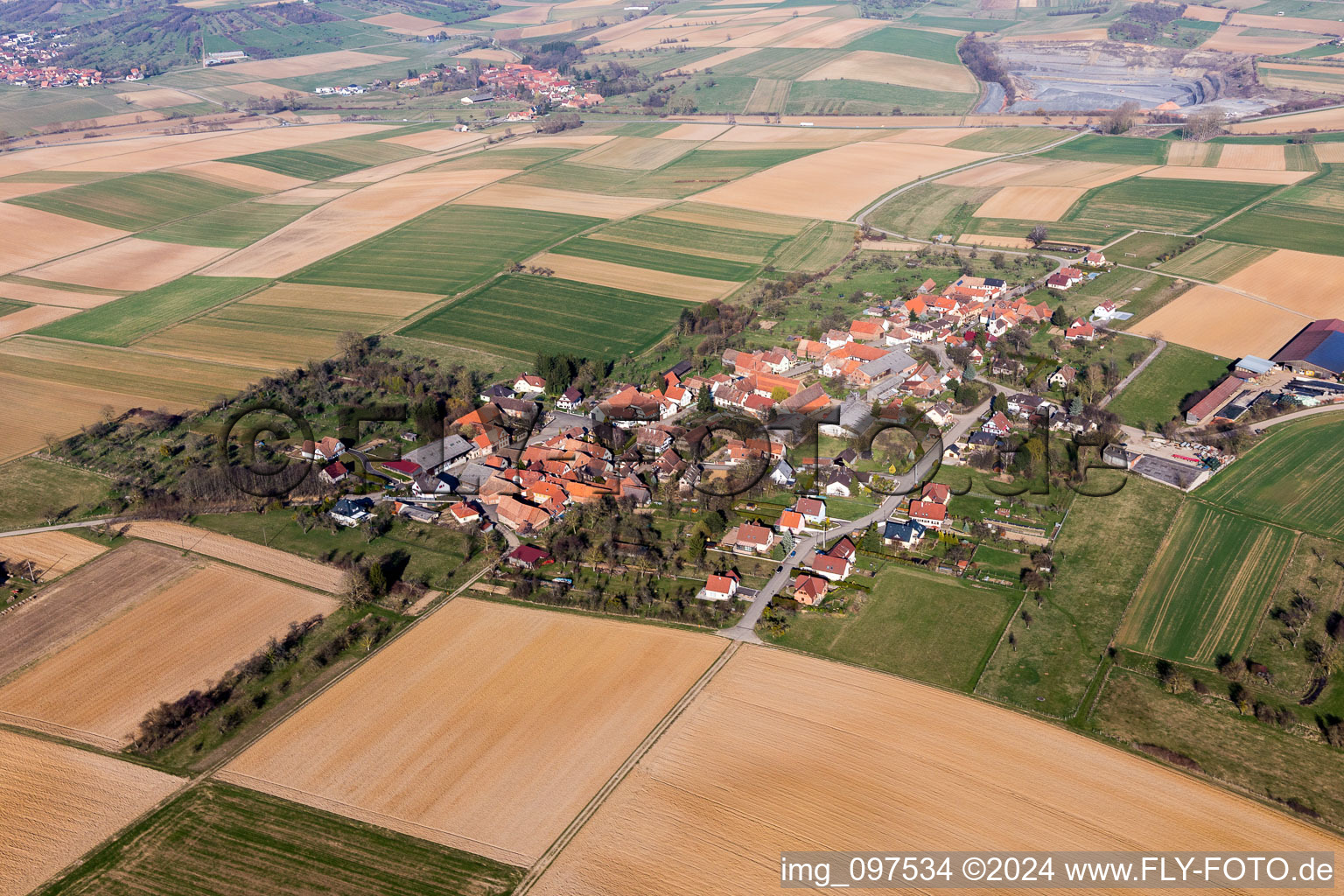 Village - view on the edge of agricultural fields and farmland in Zoebersdorf in Grand Est, France