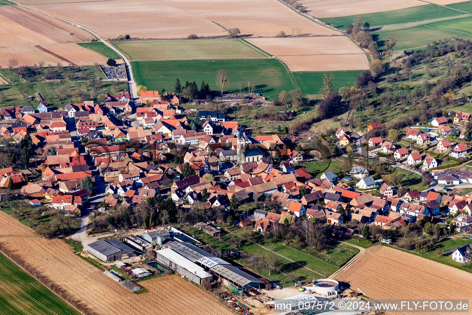 Aerial view of Village - view on the edge of agricultural fields and farmland in Melsheim in Grand Est, France