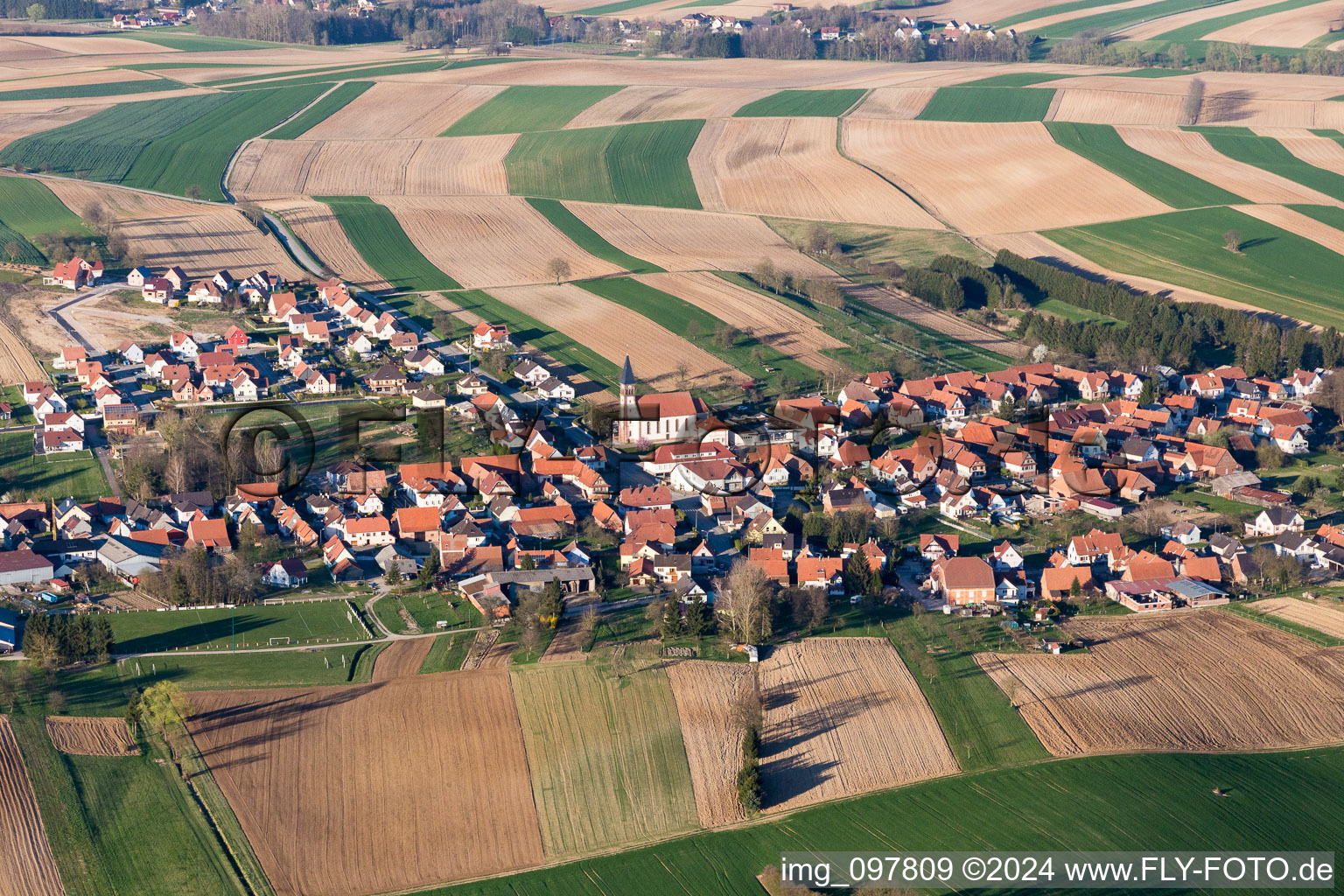 Village - view on the edge of agricultural fields and farmland in Aschbach in Grand Est, France