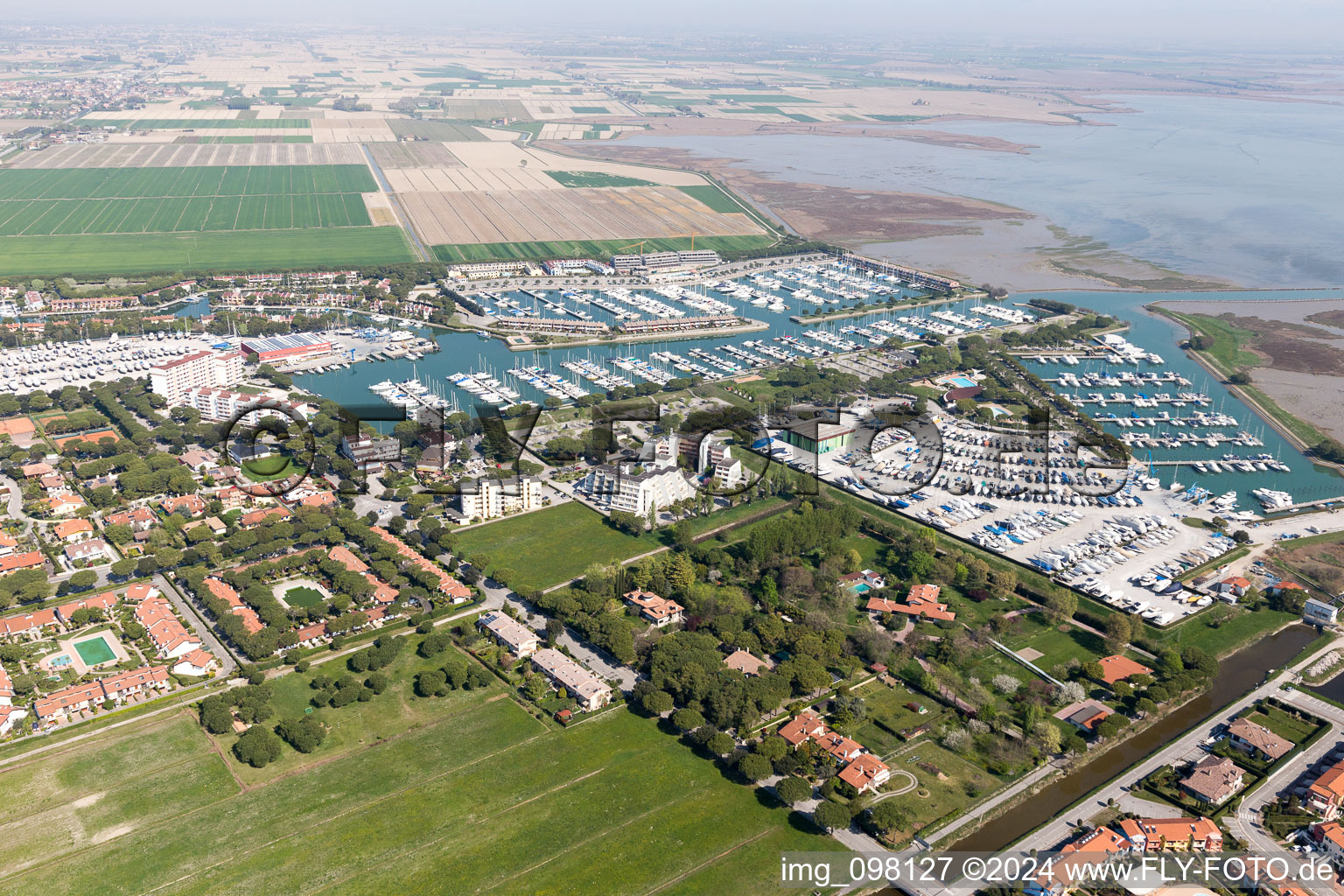 Aerial view of Pleasure boat marina with docks and moorings on the shore area of Marina Punta Gabbiani Aprilia Marittima in the district Aprilia Marittima in Bevazzana in Friuli-Venezia Giulia, Italy